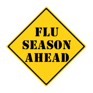 Yellow diamond warning sign with "flu season ahead"