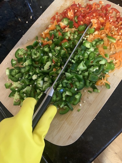 Chopping peppers with gloves on